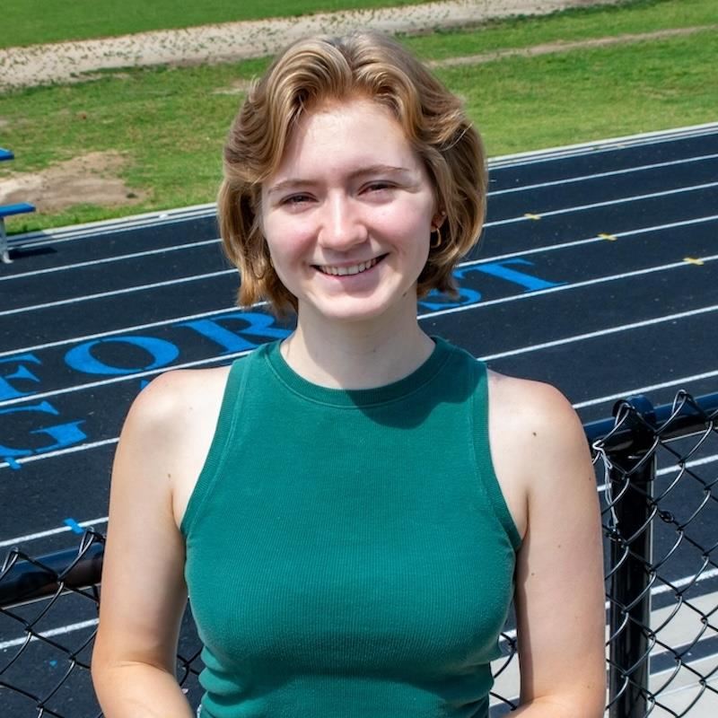 Jillian poses on the stadium bleachers